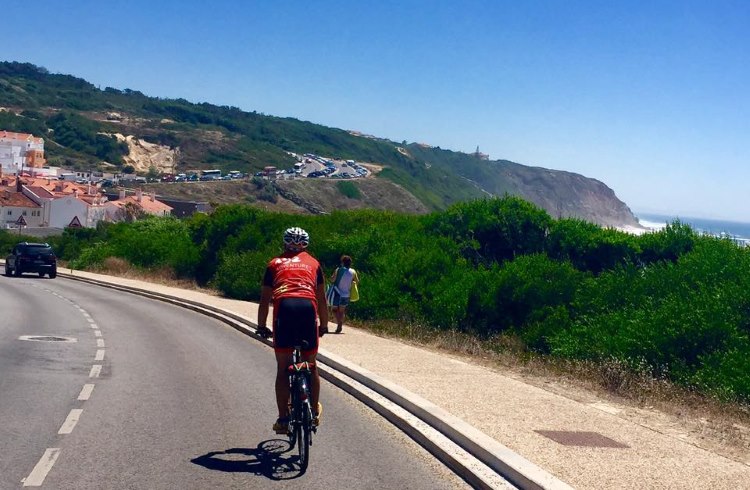 A cyclist rides the Atlantic Coastal Route near Nazare, Portugal.