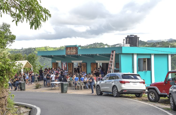 Locals enjoy chinchorreo - an afternoon of music and food, hopping from one venue to another - at a roadside reastaurant in Ciales, Puerto Rico.
