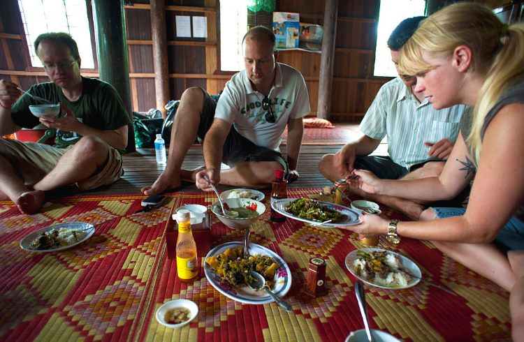 Travelers eat lunch at a homestay on Koh Trong island in Cambodia.