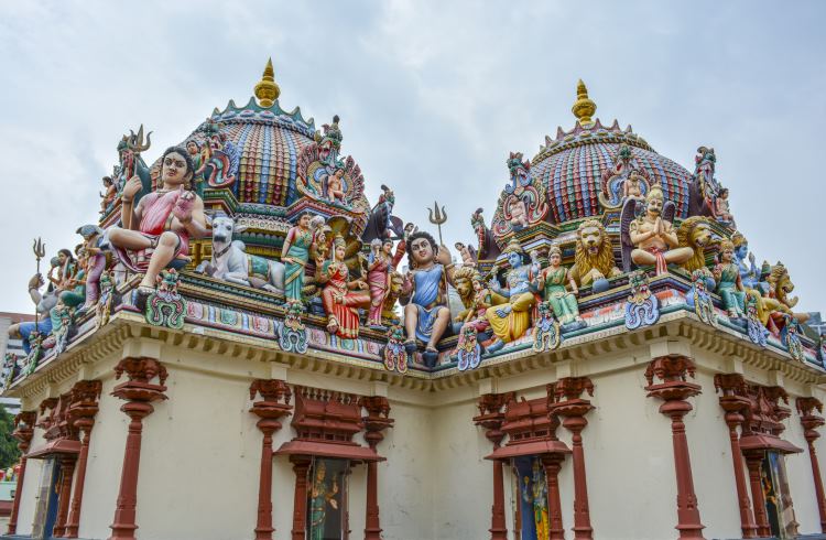 Colorful statues of Hindu gods on the roof of Sri Mariamman Temple in Singapore. 