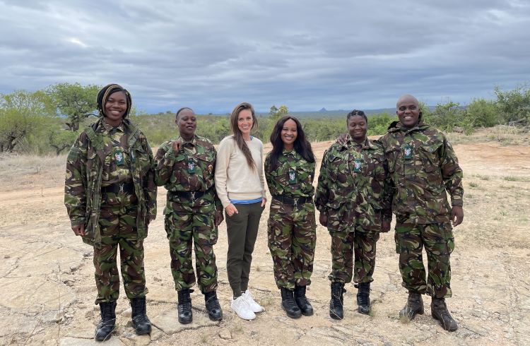 A journalist poses with five members of the Black Mambas anti-poaching unit in South Africa.