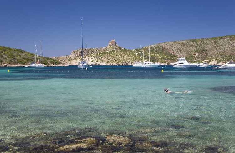 A snorkeler swims in the waters off the islet of Cabrera in the Balearic Islands of Spain.