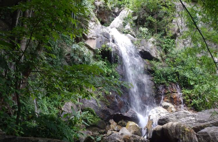 A waterfall along the path to Tarn Lod Yai cave in Chaloem Rattanakosin National Park, Thailand.