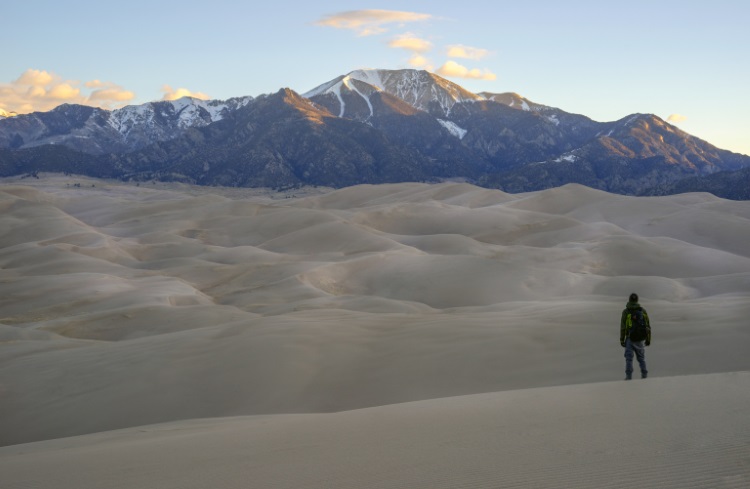 A man stands at the bottom of the Great Sand Dunes in Colorado.