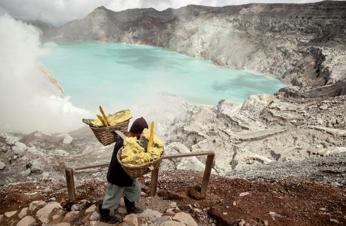 In the volcanic crater of Kawah Ijen, in East Java, Indonesia, miners carry inhuman loads of sulfur on their shoulders, from the bottom to the peak.