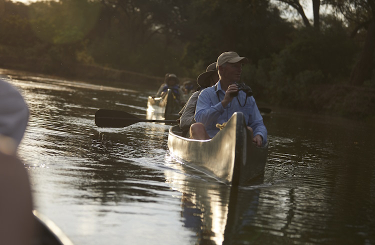 Travelers on a canoe safari in Zambia.