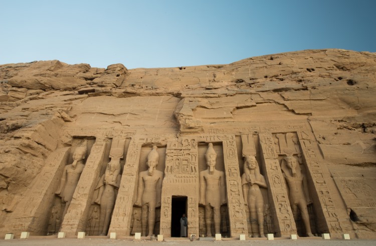 A lone guard stands inside the entrance to the Temple of Hathor at Abu Simbel in Upper Egypt.