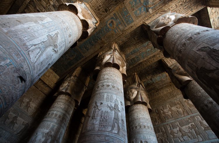 Carved columns inside the hypostyle hall of the Hathor Temple at Dendera in Egypt.