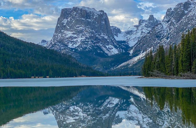 A mountain is reflected in a lake in Bridger-Teton National Forest, Wisconsin.