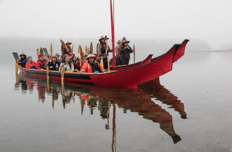 Huna tribal leaders arrive at the dedication of ther longhouse in traditional cedar canoes.