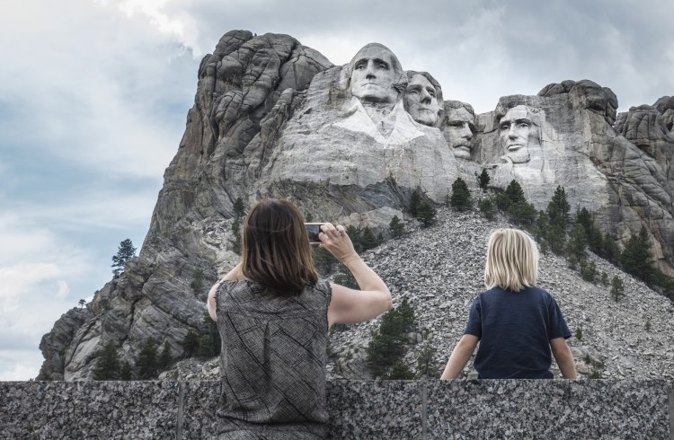 A family takes photos at Mount Rushmore, South Dakota.