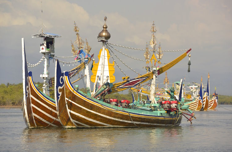 A fleet of brighly colored selerek fishing boats in Perancak, West Bali.
