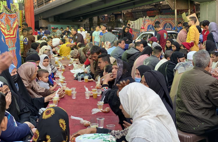 Residents of Cairo break fast at a communal meal during Ramadan.
