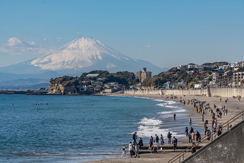 Snowcapped Mt. Fuji and the sunny beach in Kanagawa of Japan