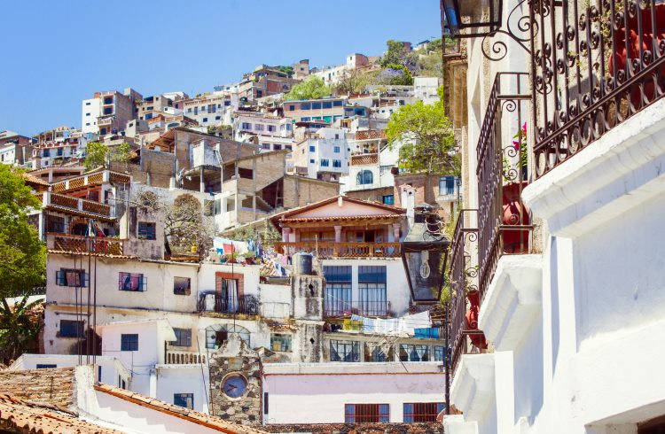 Whitewashed homes climb a hillside in the colonial city of Taxco de Alarcon, Mexico.