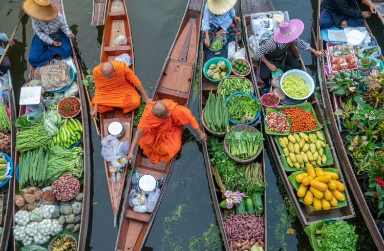 Damnoen Saduak Floating Market or Amphawa. Local people sell fruits, traditional food on boats in canal, Ratchaburi District, Thailand. 