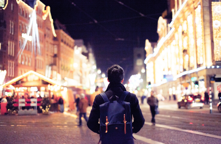 Young man walking on a street in Christmas