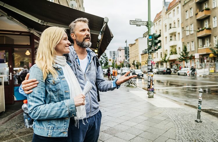 A travelling couple standing in a European street