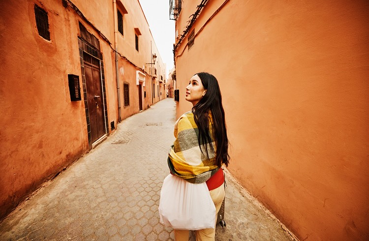 Wide shot of woman exploring the Medina of Marrakech while on vacation