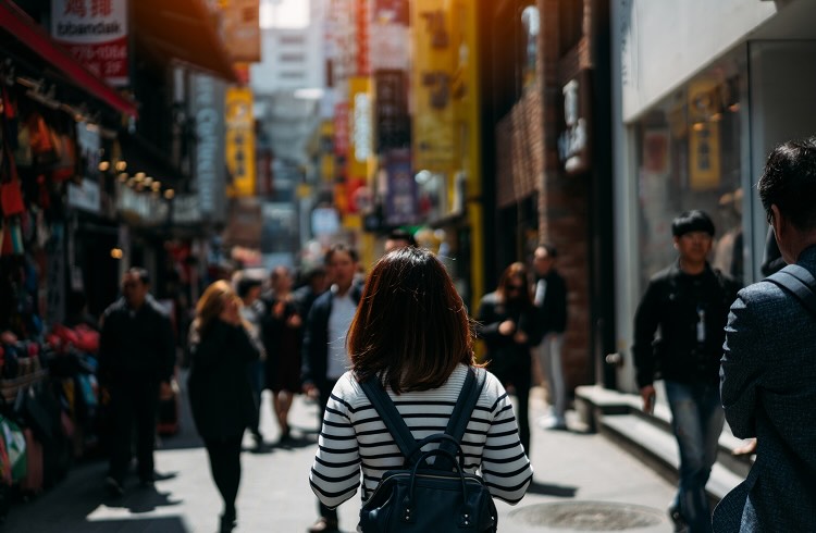 Young asian woman traveler traveling and shopping in Myeongdong street market