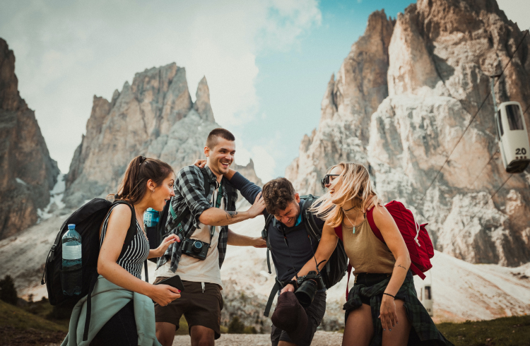 A group of friends laughing in front of mountains