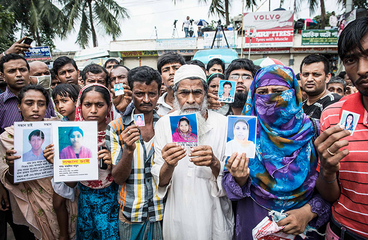 Families holding photos of missing loved ones in Bangladesh