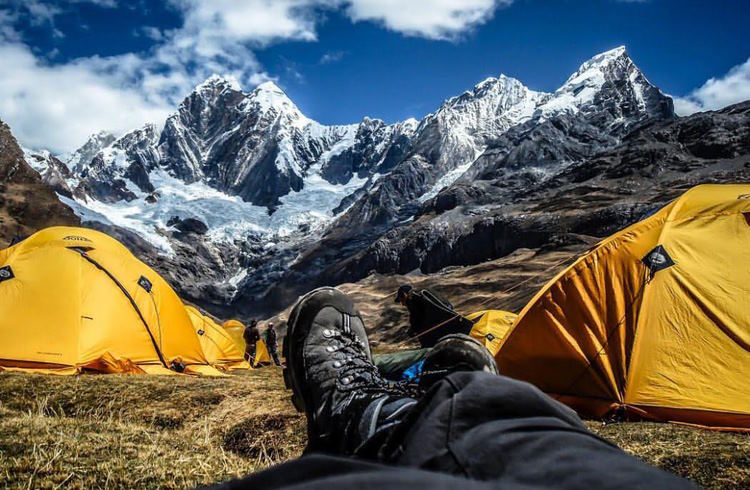 POV shot of a backpacker looking out of his tent at the Himalayan mountains.