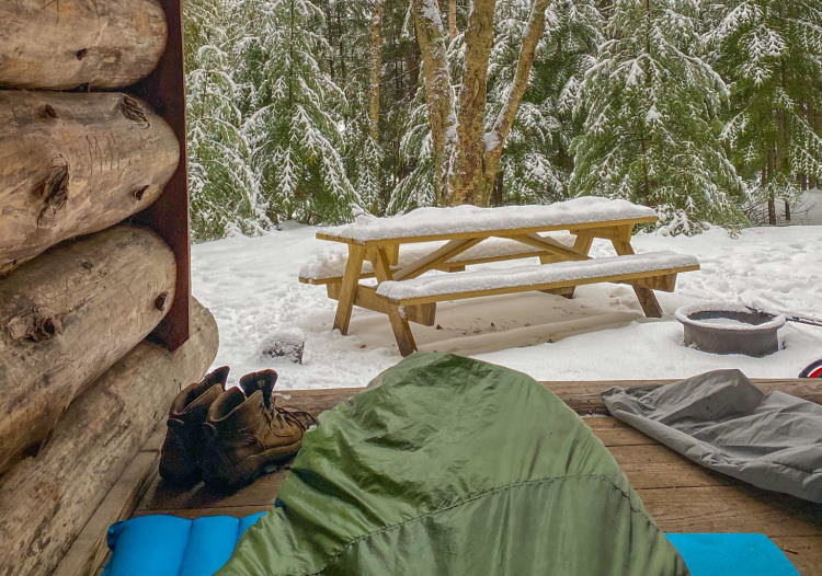 Looking out onto a snowy landscape from a camping shelter in the Adirondacks.