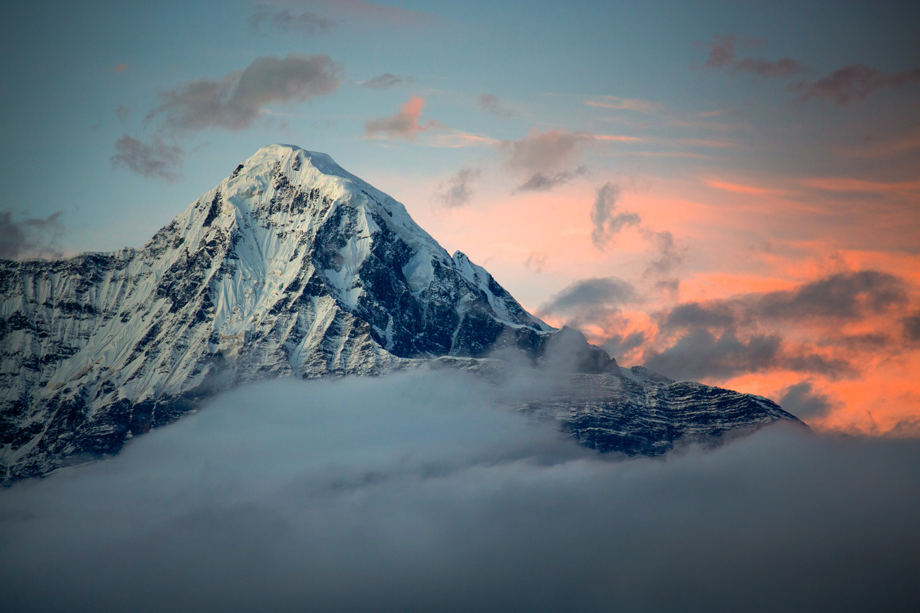 A snow-covered mountain at sunrise