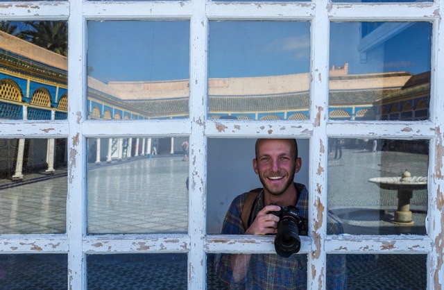 James with his camera looking out a window