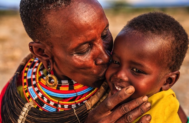 Mother from Samburu tribe, East Africa, kissing her baby.