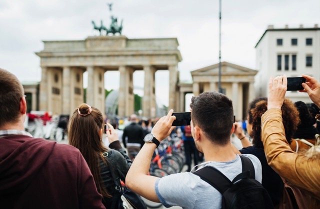 Group Of People Travelling Together Take Pictures Of Brandenburg Gate