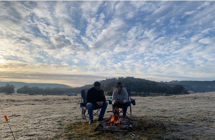 couple sitting in a frosty field
