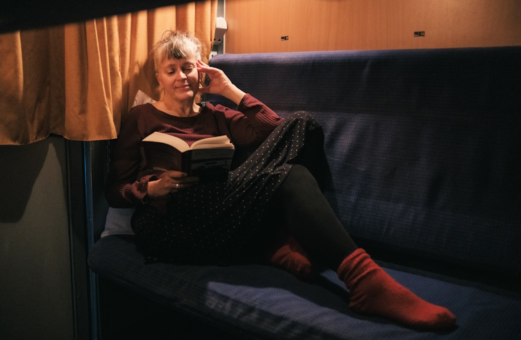 A traveler reads aboard the European Sleeper train.