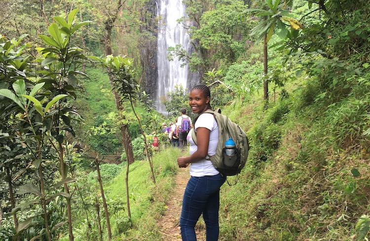 Women hike to a waterfall