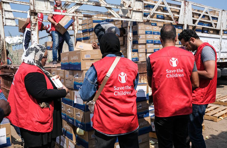 Aid workers funded by Save the Children organize humanitarian aid in Gaza.