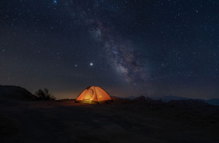 A tent under the stars at night