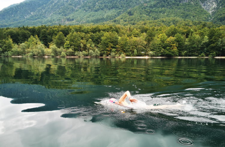 A woman swims in a lake in Slovenia's Julian Alps.