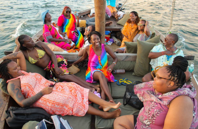 Women travelers aboard a traditional dhow in Kenya.