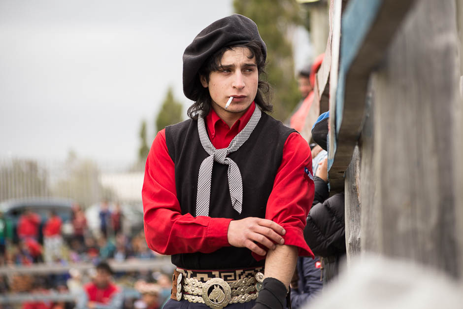 Gabriel Perez, one of the youngest riders wearing the traditional gaucho attire, preparing himself to ride.