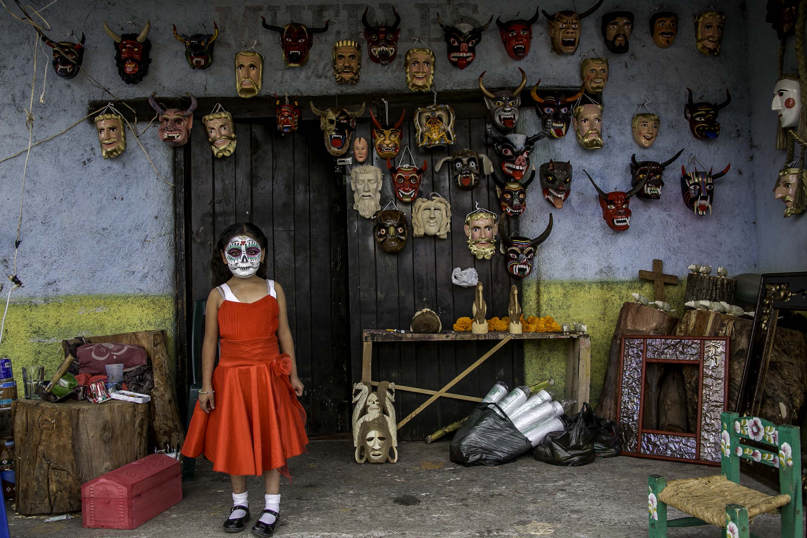 A young girl in Erongaricuaro has just prepared her mask for the celebrations. This particular small town along Lake Patzcuaro is know for its carved wooden masks. From infants to aged adults, family joy is the essence of the tradition.
