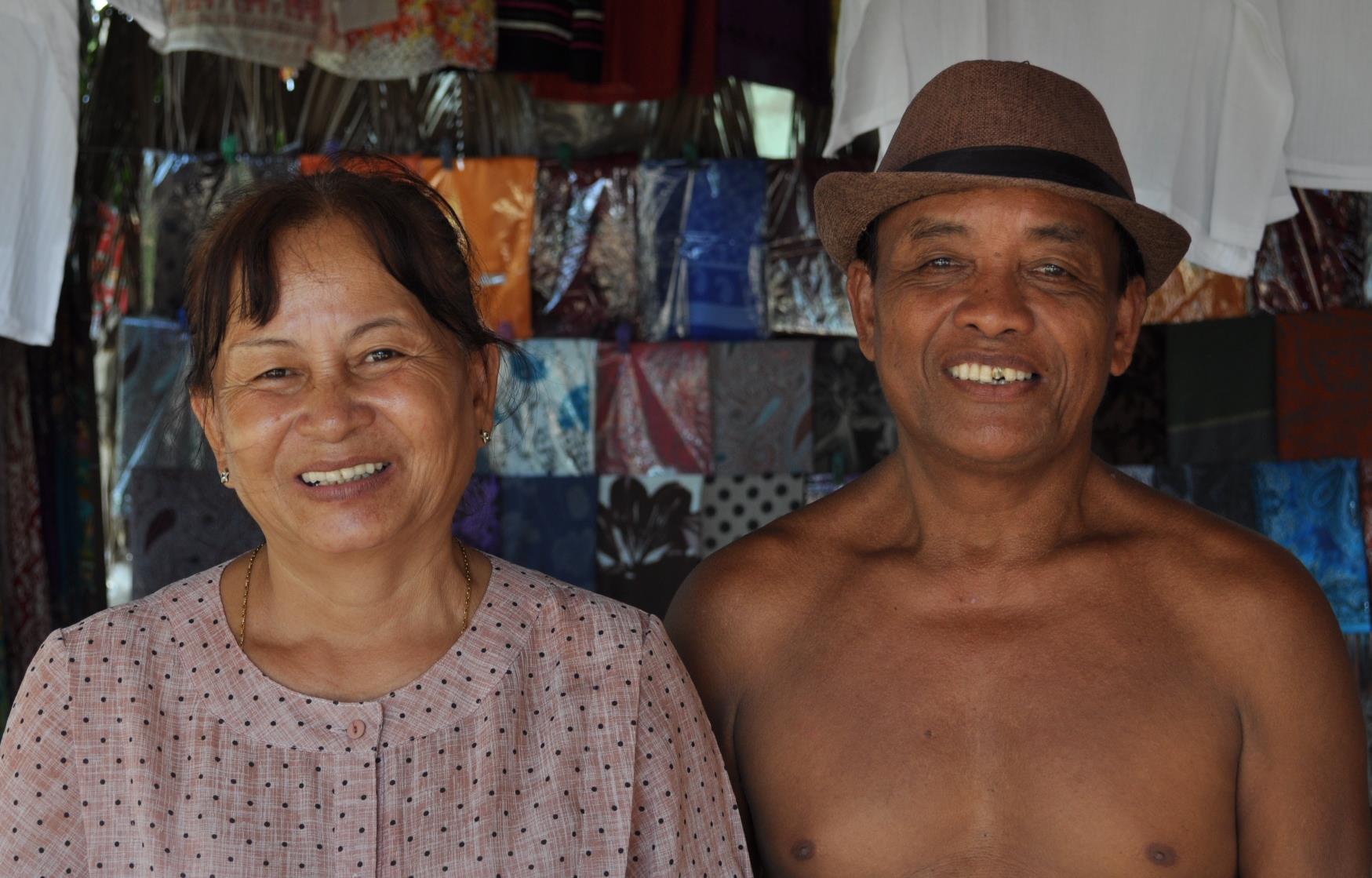 ‘All you need to have is a lovely smile for a pose’. Shop owners at the Bamboo Train station platform, Battambang, Cambodia.