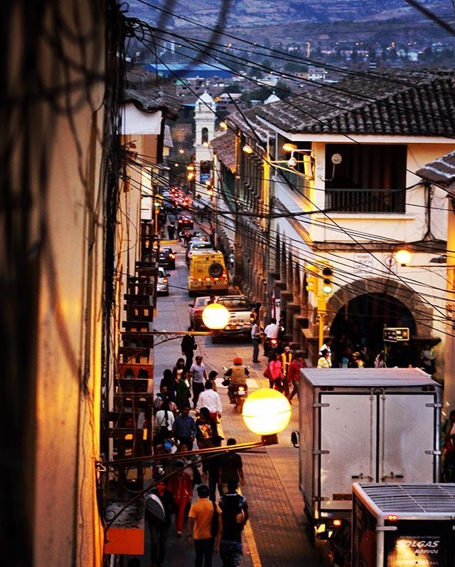 Locals and tourists crowd the streets of Ayacucho, Peru as evening takes hold of the day.