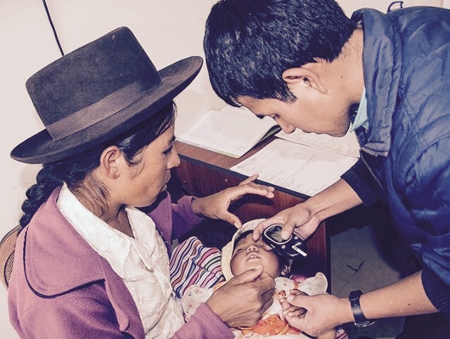 A mother brings her sick son to the only clinic in the town of Tambo,Peru awaiting the annual medical care provided by a United States led medical mission.