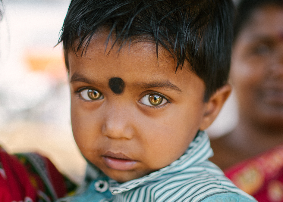 Sanjay, 2, holds tightly to his aunt. In some areas of India progress has been made to raise awareness of leprosy; his family refuse to give up hope that the disease will be defeated.