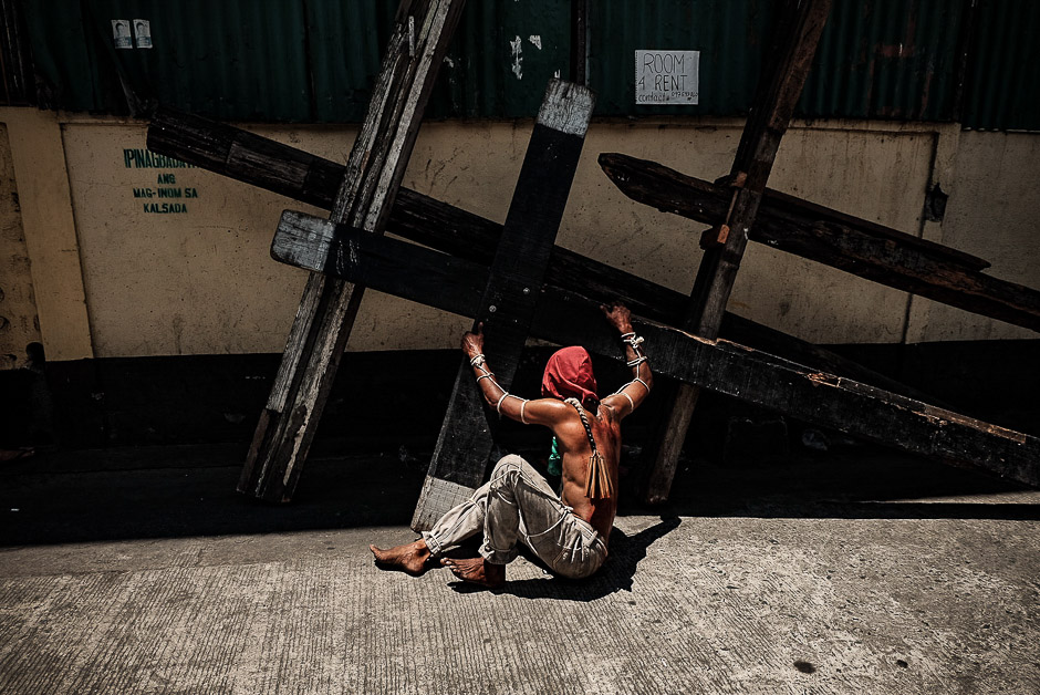 A cross carrier “Namamata” rested after hours of parading. He carried wooden cross weighing a ton, on the streets of Brgy.Tolentino. 