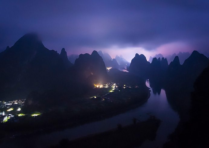 Xingping, China. Even in a downpour, towering above the tiny Chinese villages below and surrounded by the karst landscape was surreal. Along this river, lies one of the most interesting and oldest traditions in the country. 
