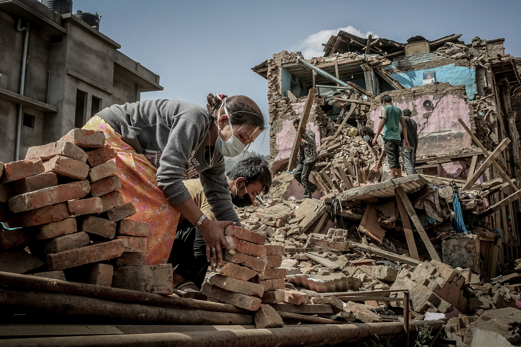 People are cleaning the rubbles of the destroyed buildings. Sankhu, Nepal. May 3, 2015.