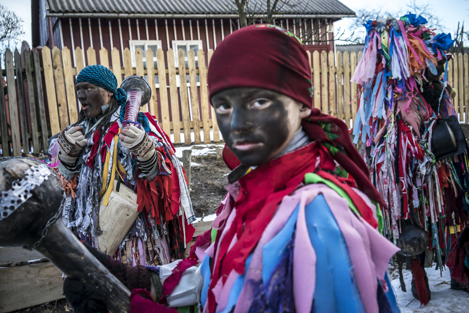 A boy wearing a costume of a ''Gypsy'' is walking from house to house celebrating Malanka in Krasnoilsk, Chernivtsi region, Ukraine