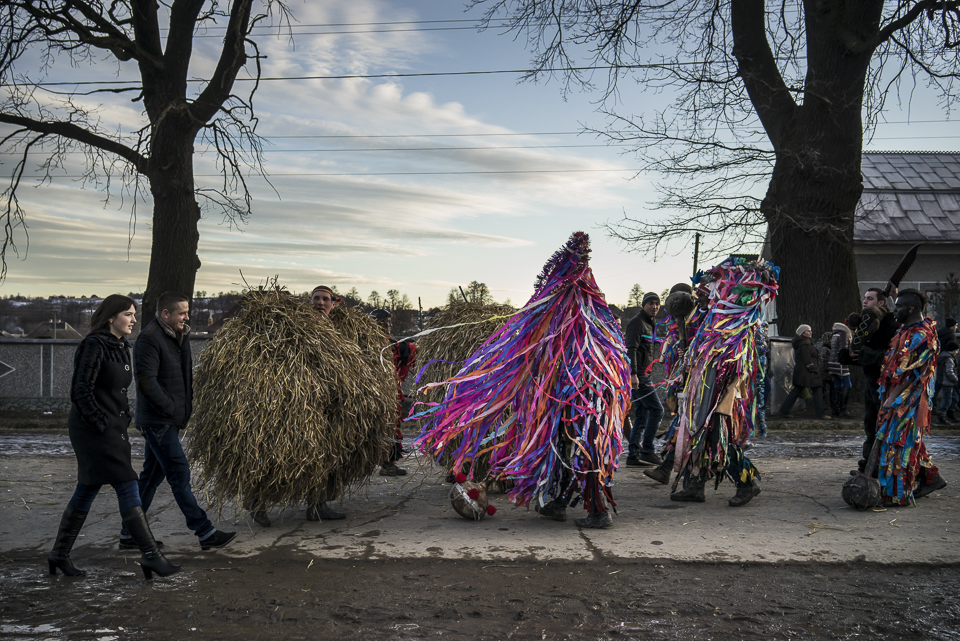 Dressed villagers are finishing their long day of Malanka festivities walking to the centre square in Krasnoilsk, Chernivtsi region, Ukraine